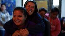 Sara and Natalia, 22, from Honduras, participate in a team building activity for a women’s group run by IRC at the shelter.