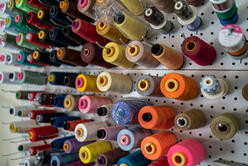 Spools of thread in Lincy's home workshop