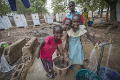 Girls fetch water at an IRC-installed pump