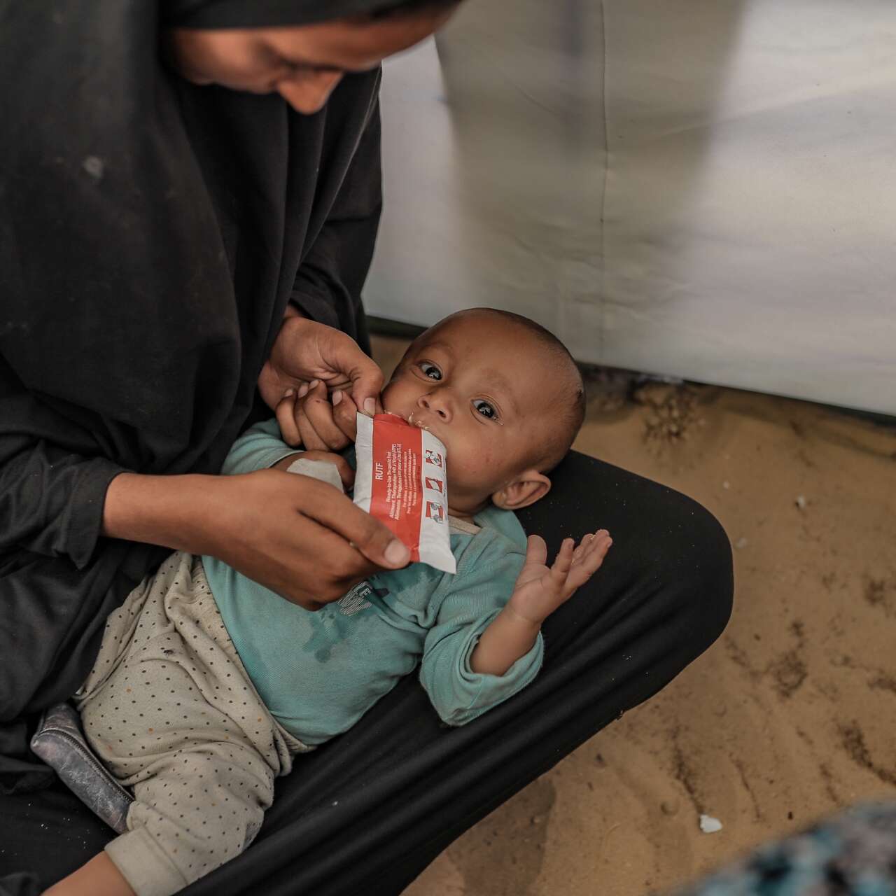 An infant in Gaza is treated for malnutrition by an IRC health worker.
