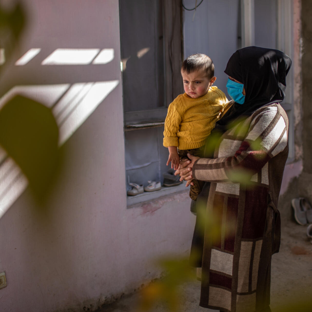 Zulaykha, an Afghan mother of four, holds her one-year-old son