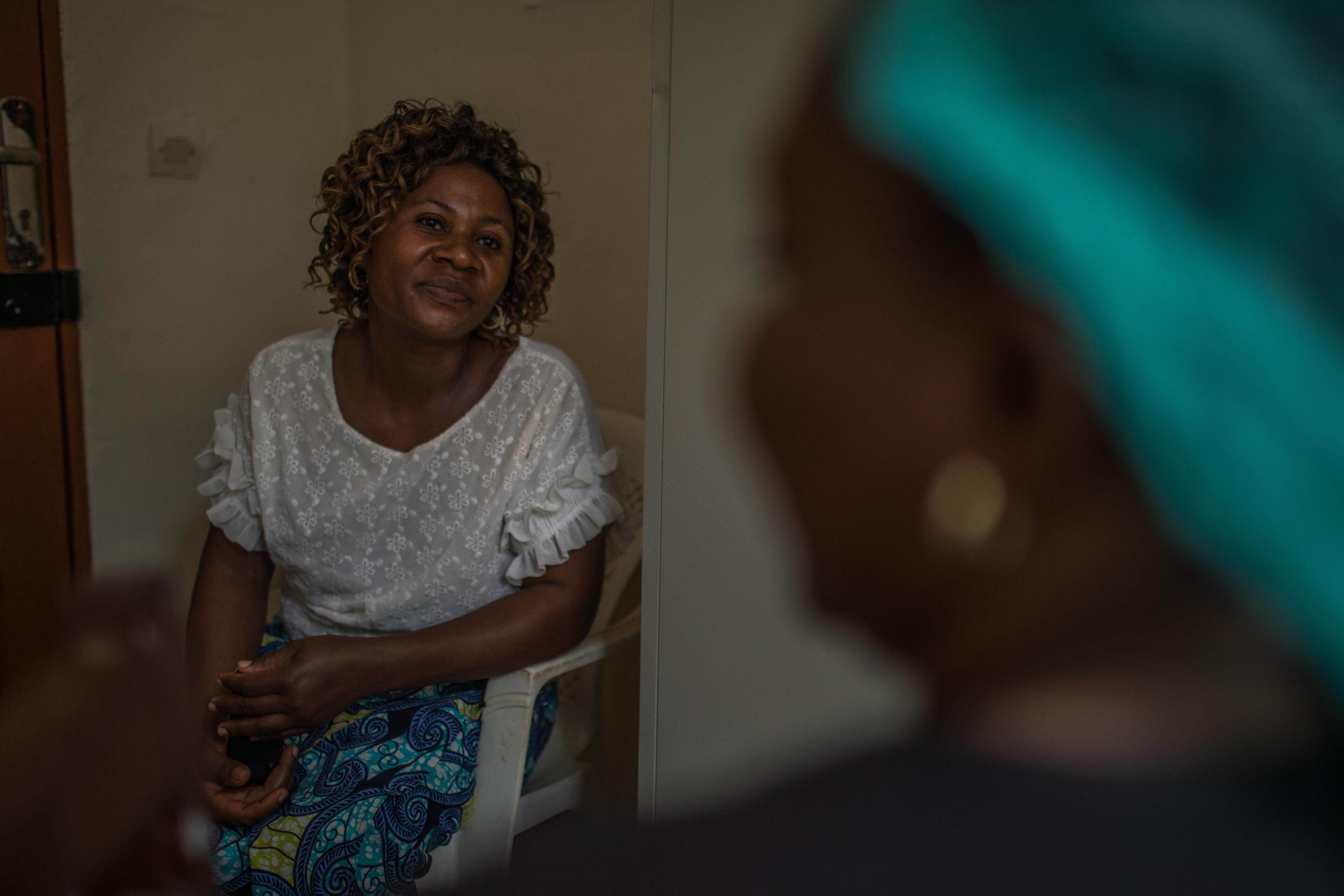 An Ebola survivor in Congo receives mental health support from International Rescue Committee staff member seated across from her.