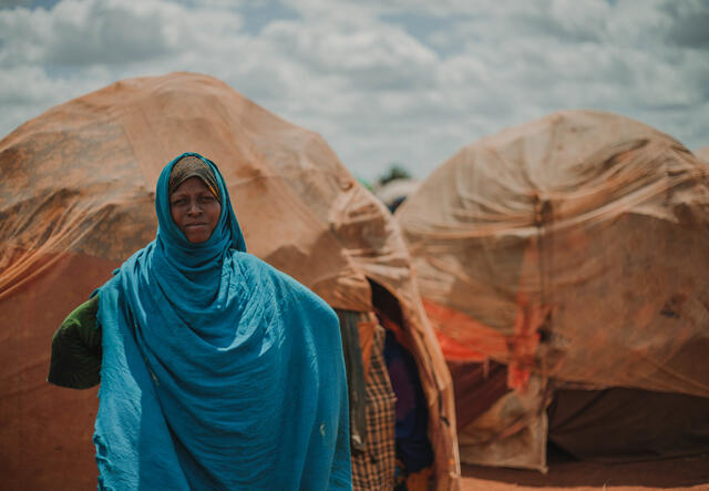Bistra Abdullahi stands in front of her home in Tortorow camp in Somalia.
