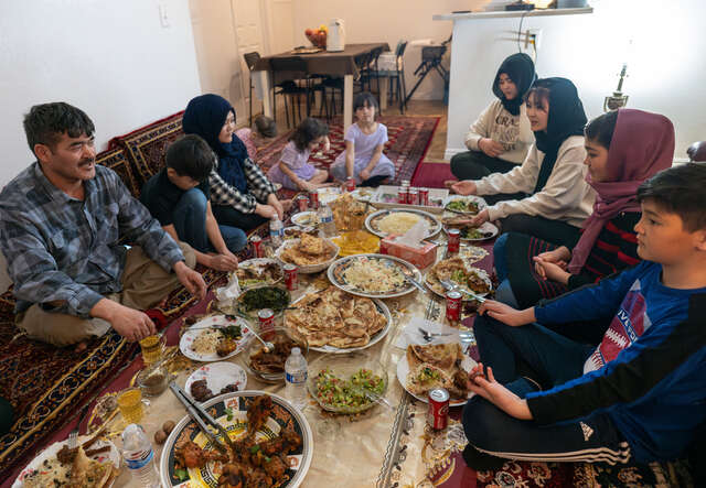 Hussaini family sit around their spread of prepared Iftar food.