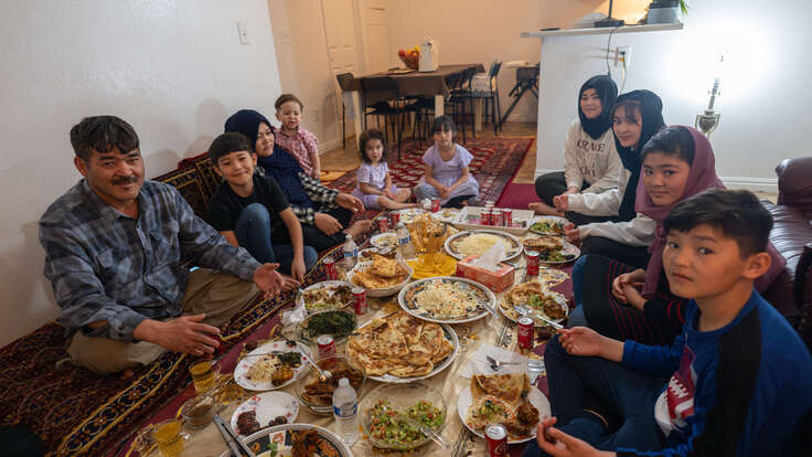 The Hussaini family sit around their prepared Iftar meal.