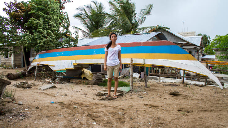 A child standing in front of the the boat that rests where Marilyn Belga’s house once stood.