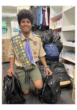Young person displaying two backpacks