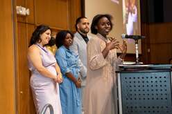 Shella Munezero (speaking) and Nuni Ndwumwami (second from left) accepting the Hope Award presented by IRC staff Rachel Mordecai (left) and John Bancheri (third from left)