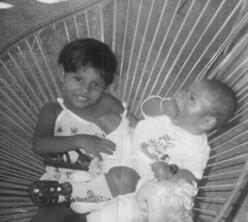 DACA recipient Lupe at age 2 with her baby brother