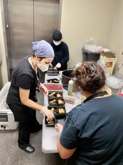 Chefs Muha and Mayada prepare meals for members of the Kansas City Chamber.