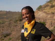 A woman wearing an IRC shirt looking into the camera and smiling