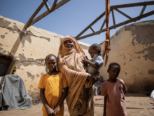 Altuma (45) and her children stand outside their roofless shelter in Gedaref, Sudan 