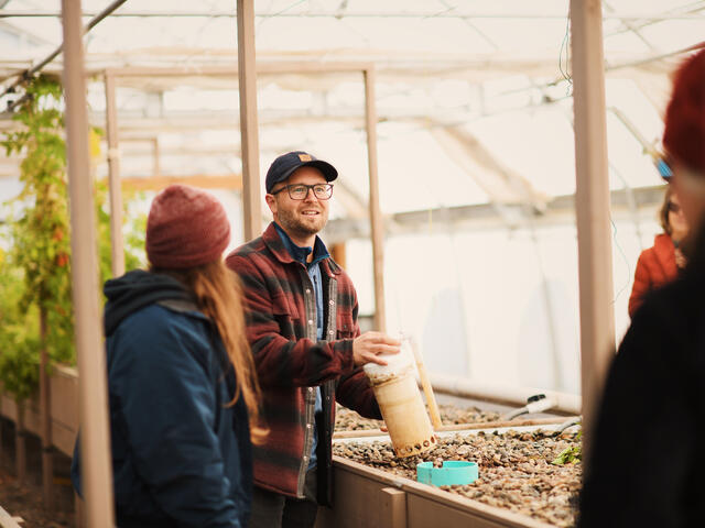 Isaac Jensen provides tour of the Camel Backyard Greenhouse.