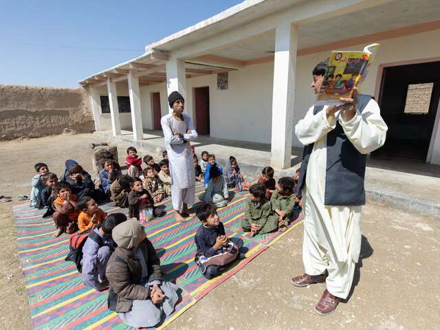 A class being taught outside at the IRC's Accelerated Learning Program (ALP) institution in Chaman, Balochistan. All of the students in the program belong to low-income, marginalized families, and many of them are refugees.