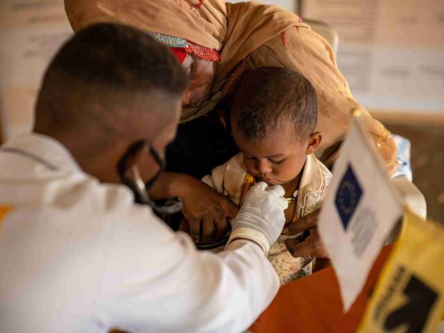 With funding from the European Union, Dr. Mogahed treats a child at the IRC's medical clinic, where he frequently encounters cases of child malnutrition, chronic illnesses, mental health conditions and febrile diseases.