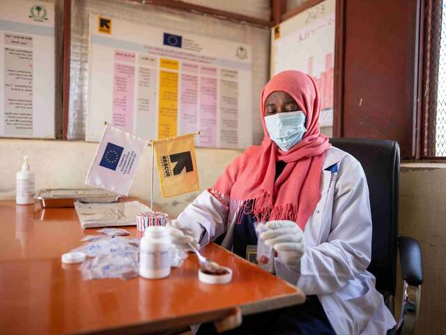 Midwife Zakia Yaqoup, 43, carefully prepares prenatal vitamin packs containing folic acid and iron at the IRC's antenatal care and family planning section. 