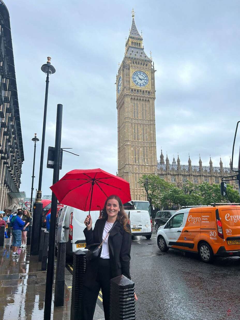 IRC client Iryna stands in front of Big Ben and Parliament in London