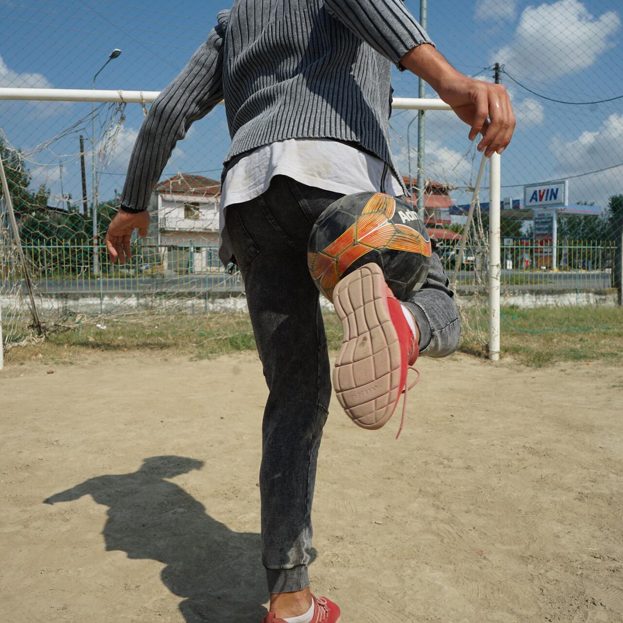boy makes a trick with a football