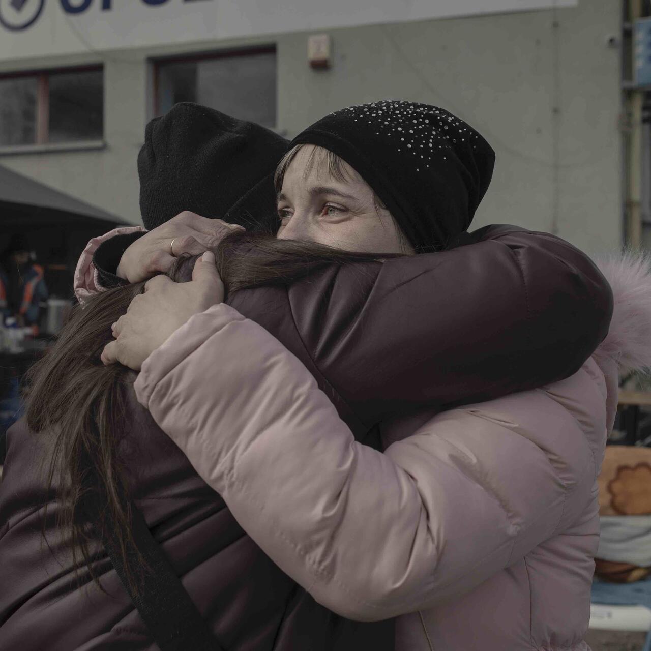 A mother and her daughter meet at the Medyka border crossing point, Poland