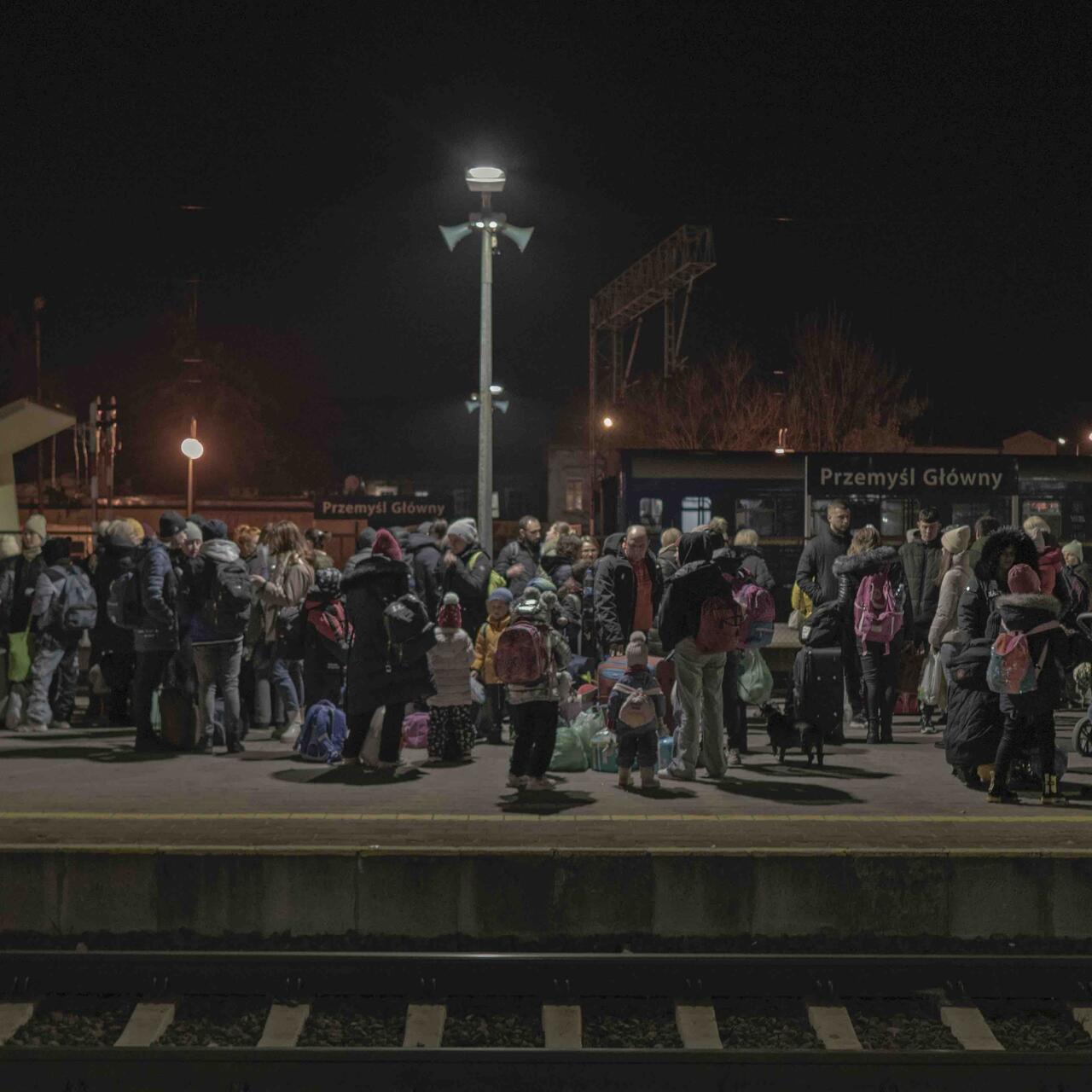 Ukrainian refugees wait at Polish railway station