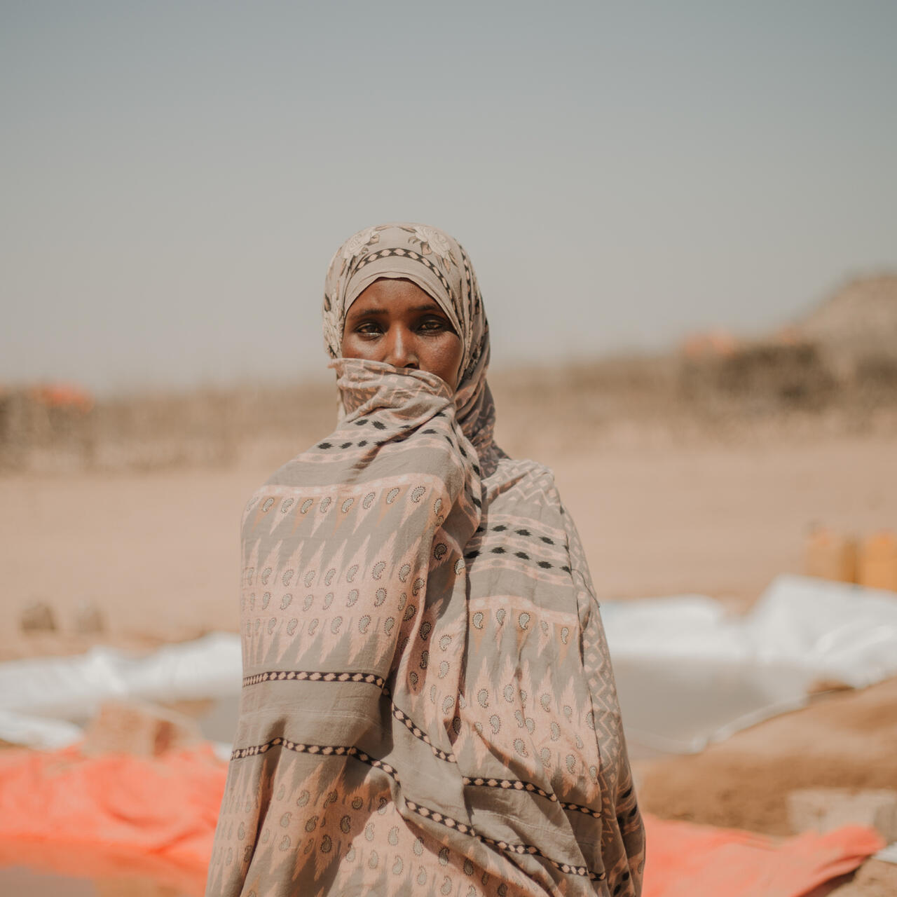  Bilan, 40, stands facing camera at Kambe Kebele water point.