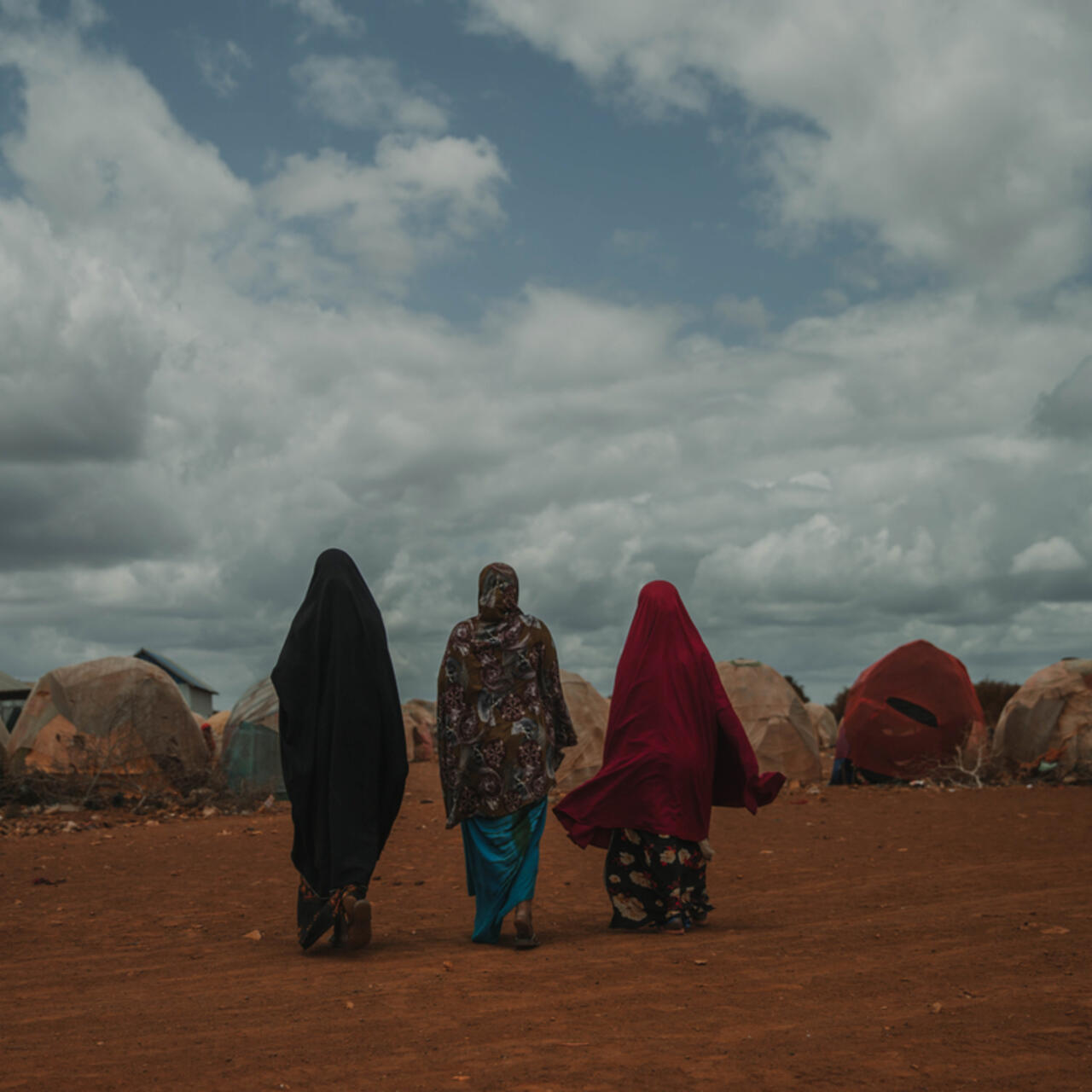 Women walk to their house, Torotorow IDP camp, Somalia.