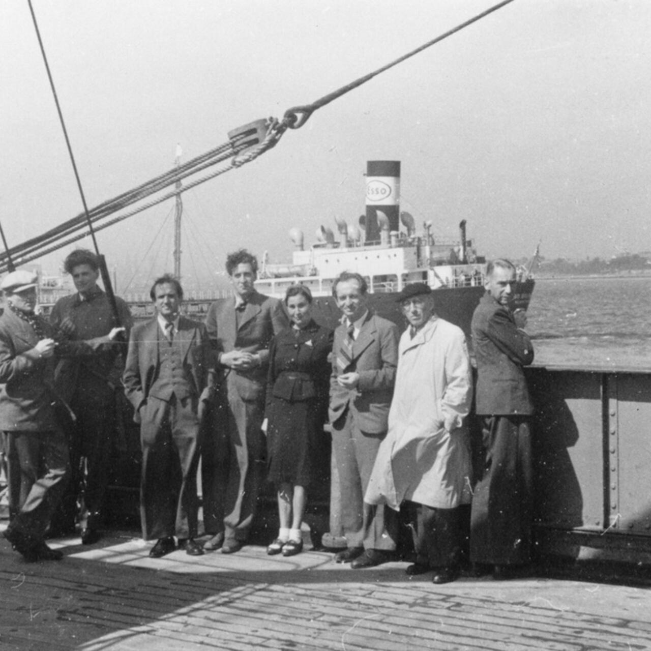 European refugees stand facing the camera, on board converted cargo ship sailing from Marseilles to Martinique, March 25, 1941. 