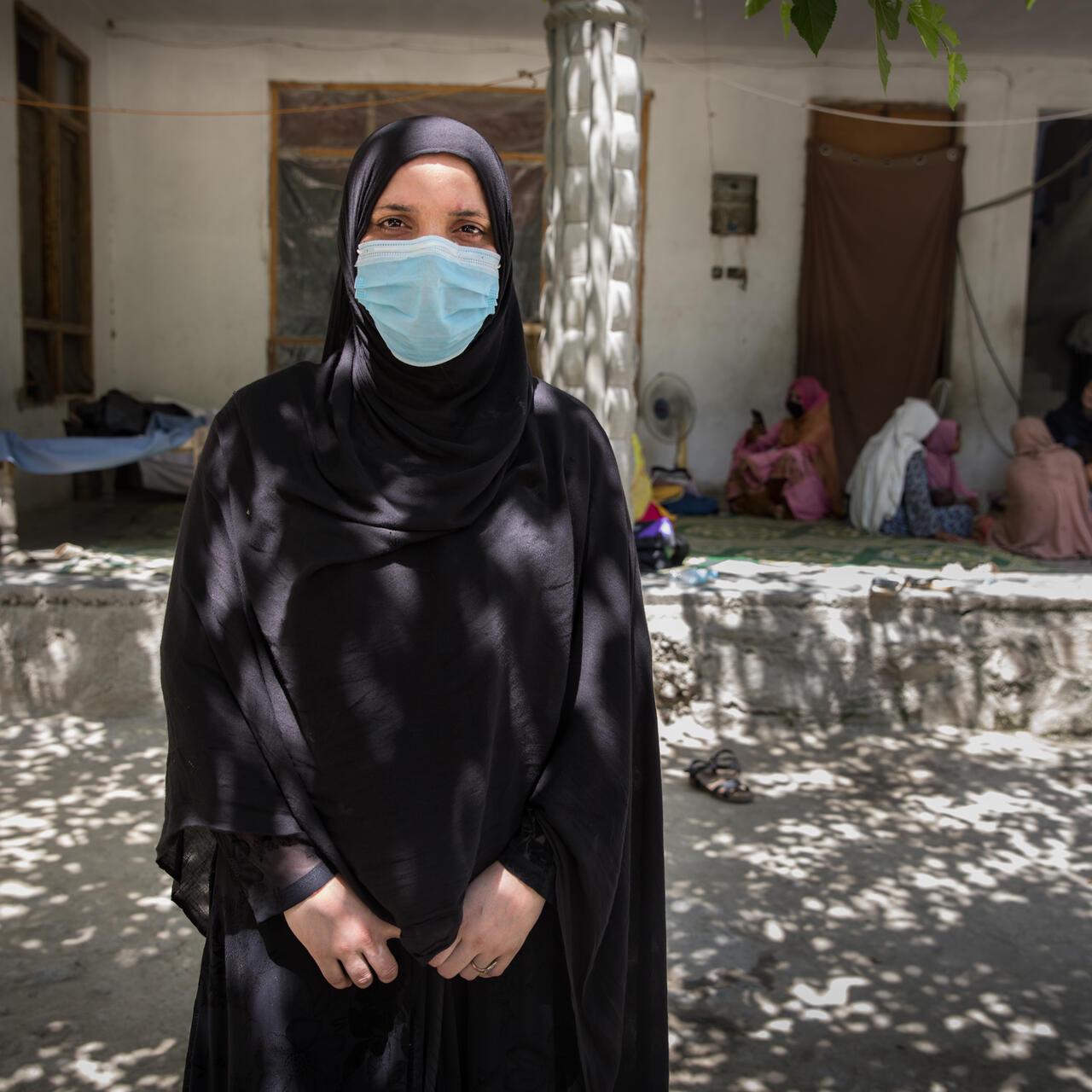 Mariam*, a 24-year-old Afghan health worker, poses for a portrait after giving a cooking class and nutrition recommandations to her community.