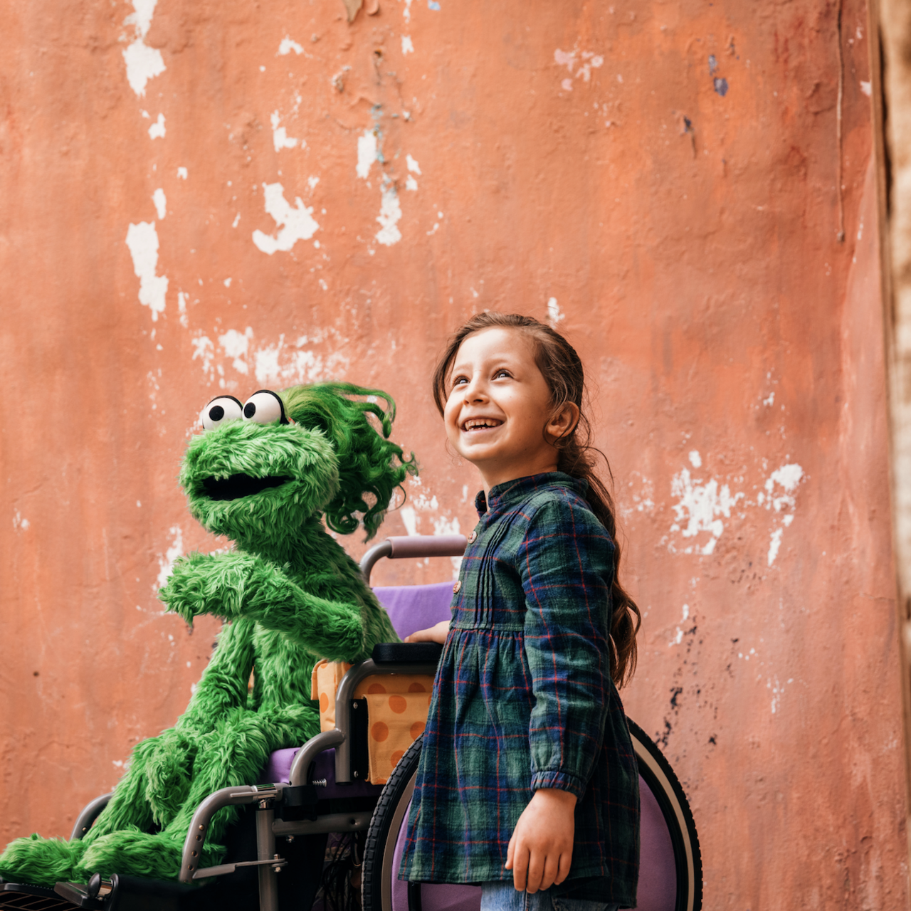 Ameera and a young child in Saida, Lebanon. Photo Credit: Ryan Heffernan/Sesame Workshop.