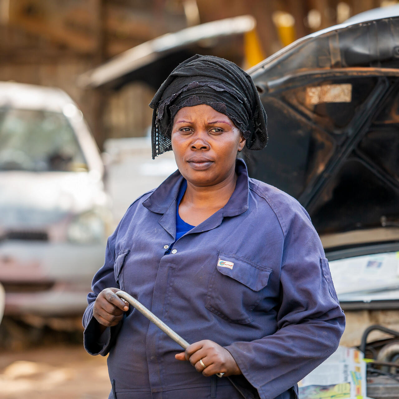 A female mechanic poses for a photo in Uganda.