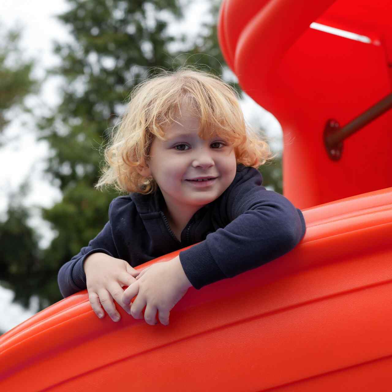 A young girl at a playground in Greece.