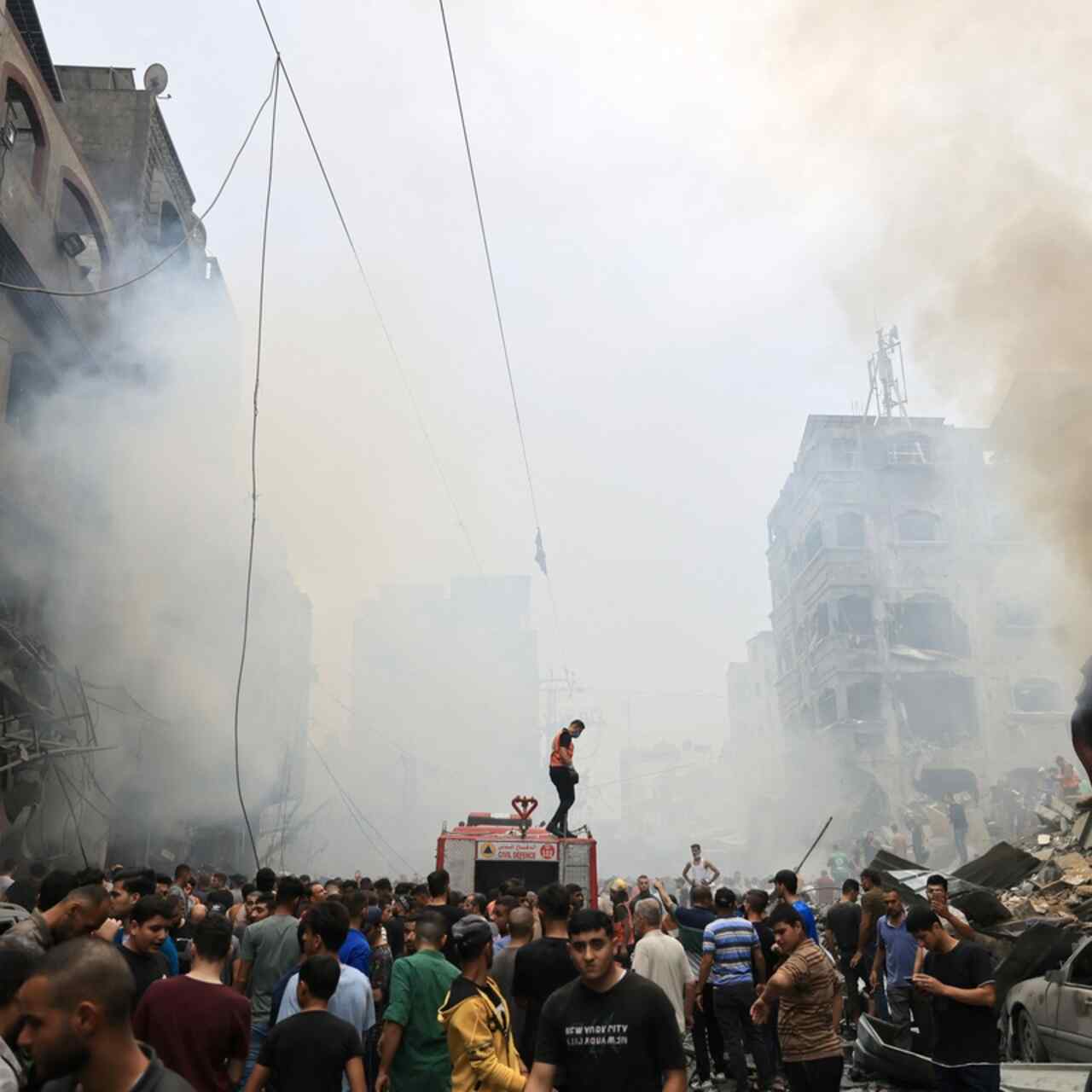 Palestinians search for survivors after an Israeli airstrike on buildings in the refugee camp of Jabalia in the Gaza Strip on October 9, 2023.