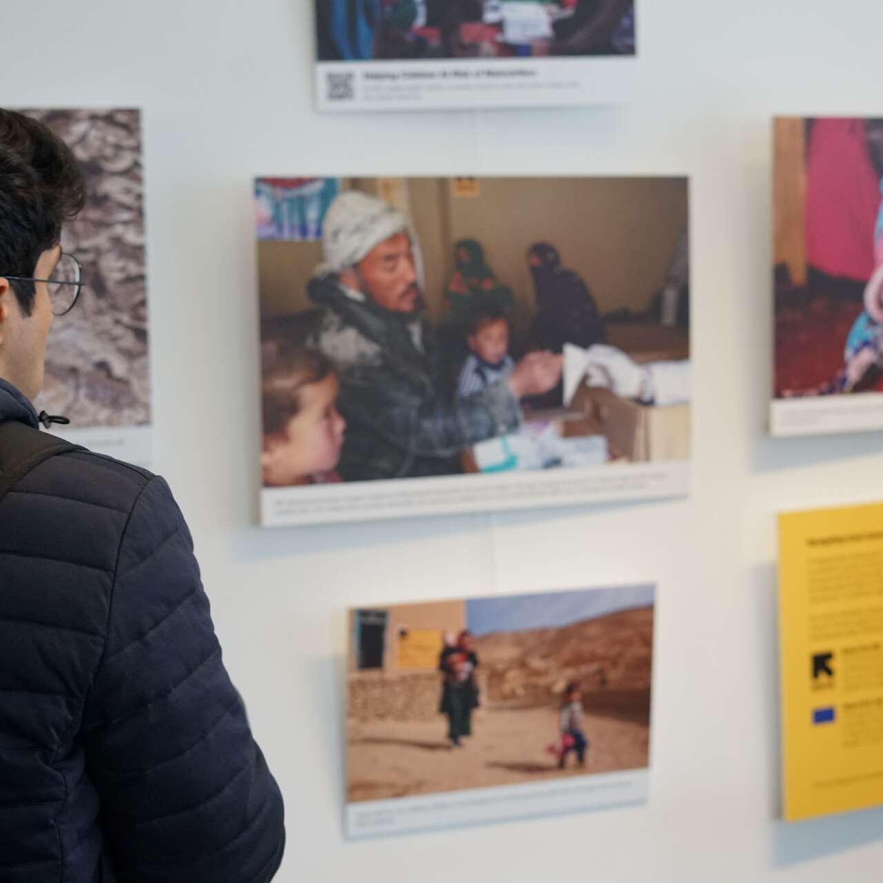 Attendee of the European Humanitarian Forum visiting the IRC's photo exhibition