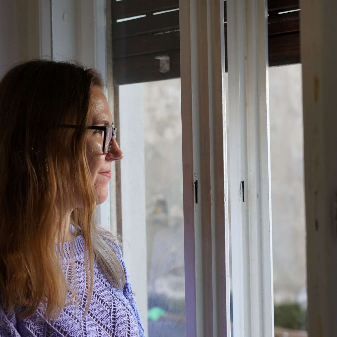 Nataliia, a Ukrainian woman in Trieste, looking out the window