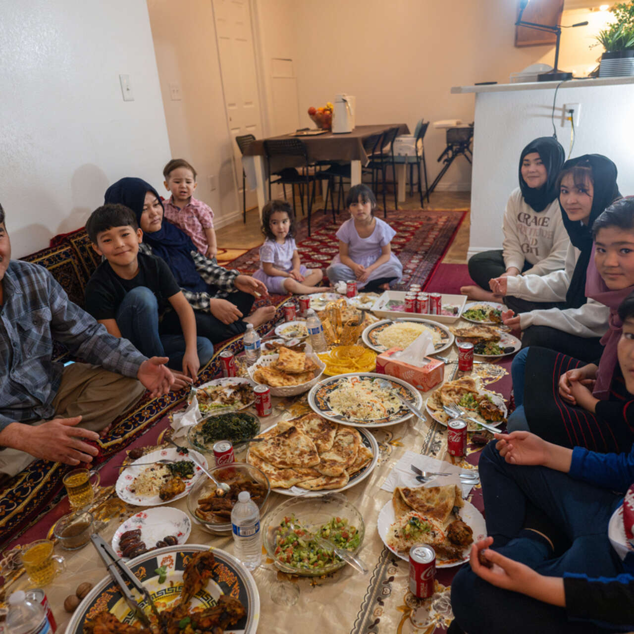 The family sit around their prepared Iftar meal.