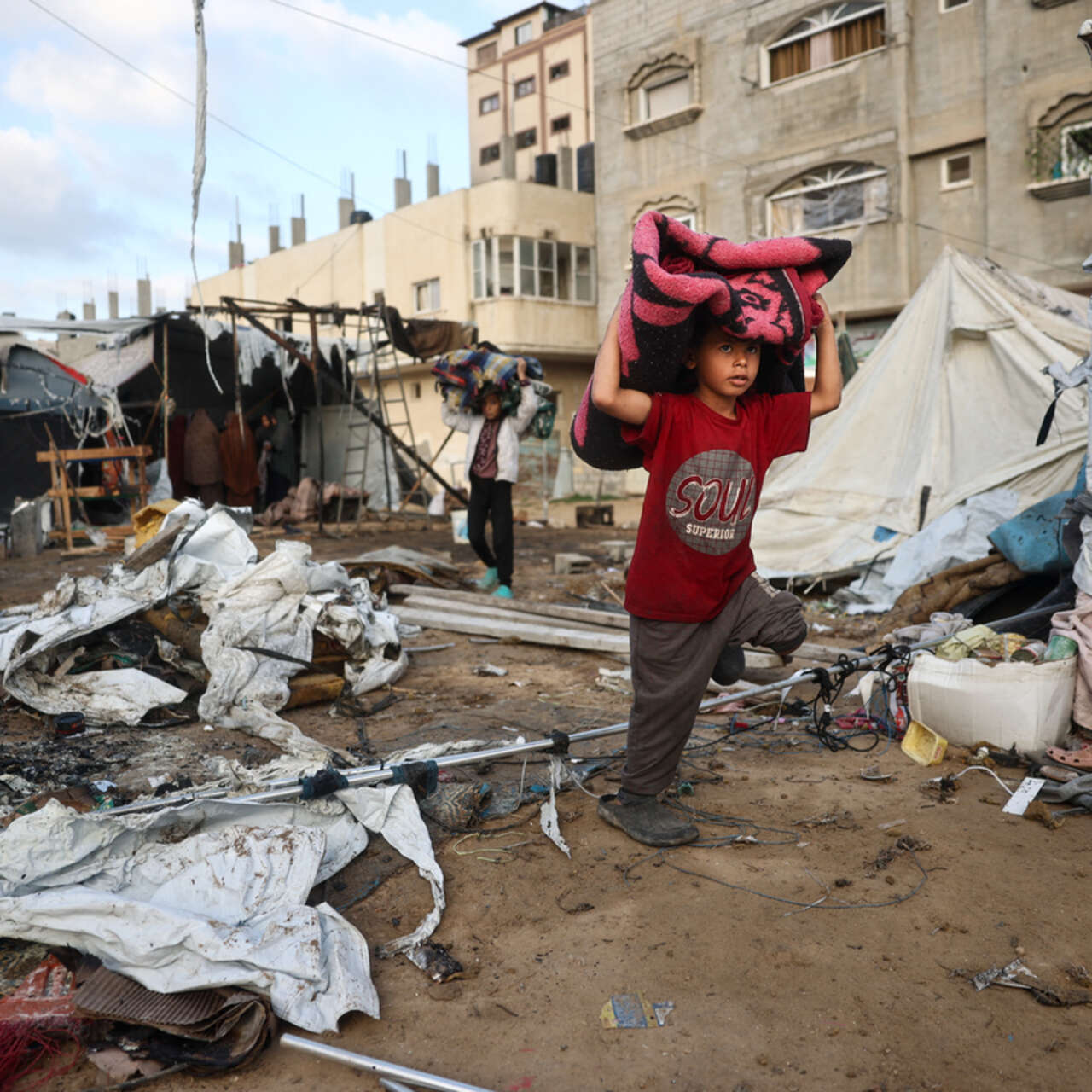 A child carries items on the Bureij refugee camp in the central Gaza Strip on October 8, 2024