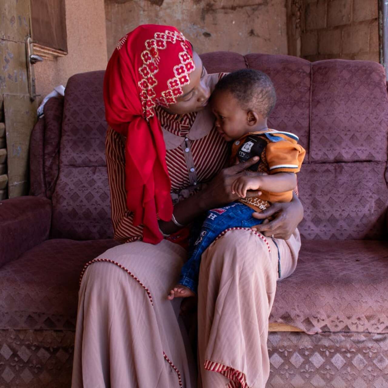 A woman with her child sitting on her lap