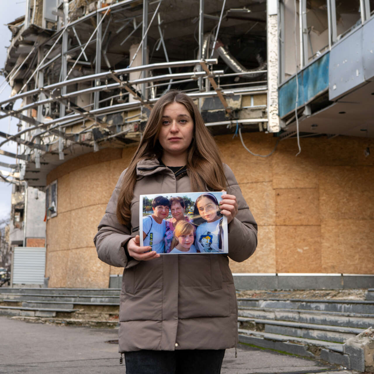 Marhartya holds a photo of her family together.