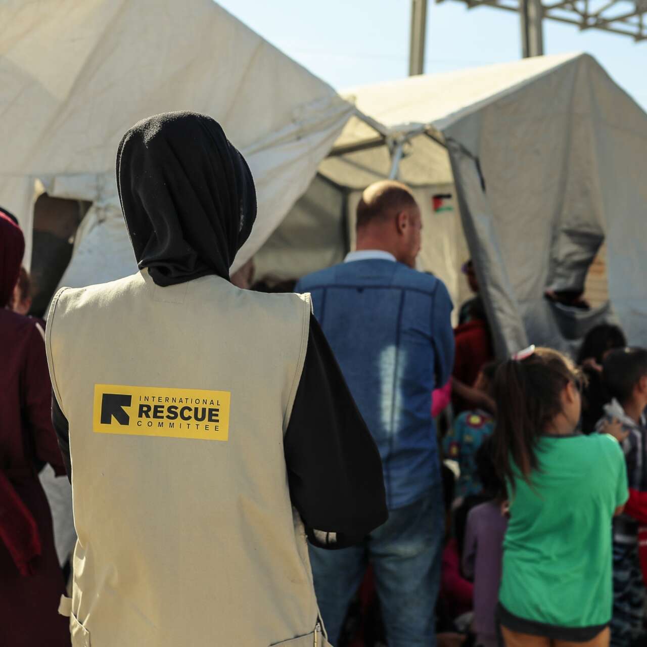 An IRC staff member stands outside an IRC-run psychosocial session for children in Gaza.