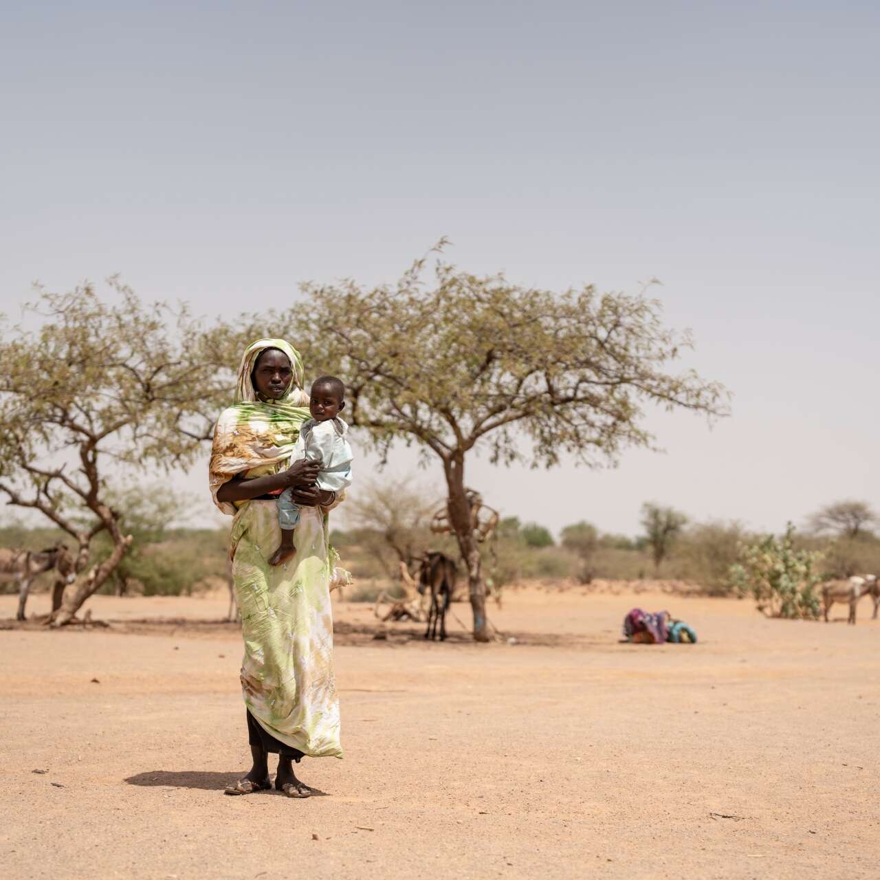 A mother holds her child in her arms as they would to an IRC health center in Chad.