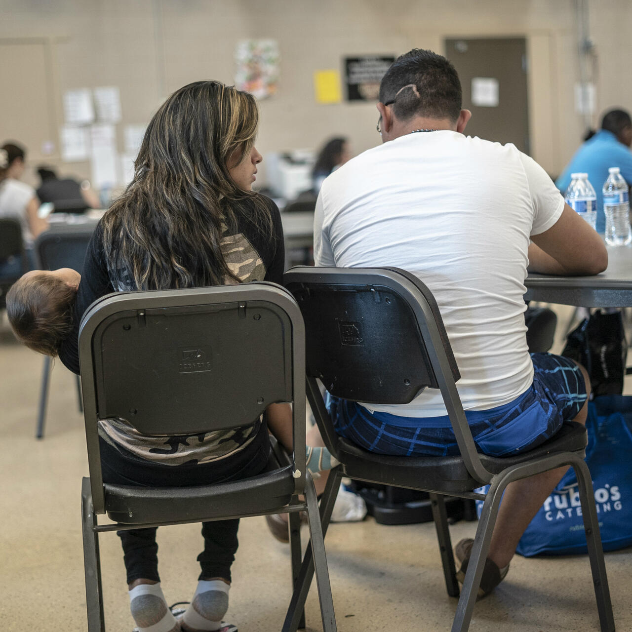 Man, woman and baby from Central America at an IRC day center for asylum seeker sin Phoenix, Ariz.