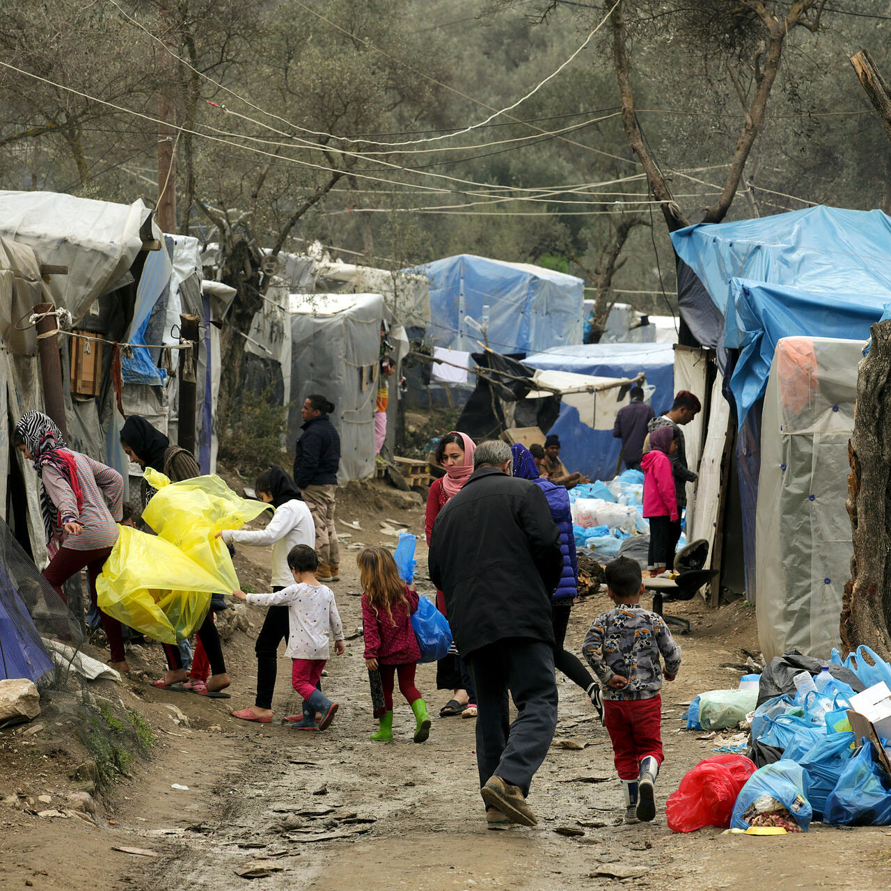 People walk between the crowded rows of tents in Moria refugee camp