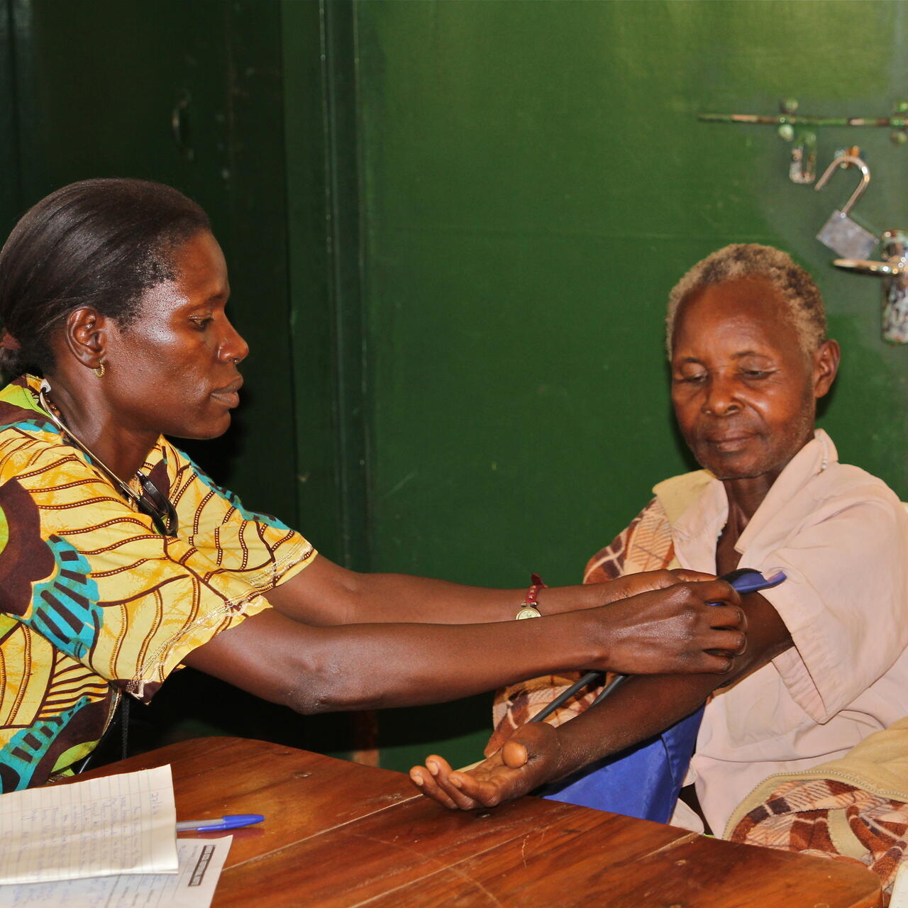 Psychiatric nurse tends to a South Sudanese woman living in Uganda's Kiryandongo refugee settlement. There is just one psychiatric nurse in the settlement who currently refers extreme cases to Kampala.