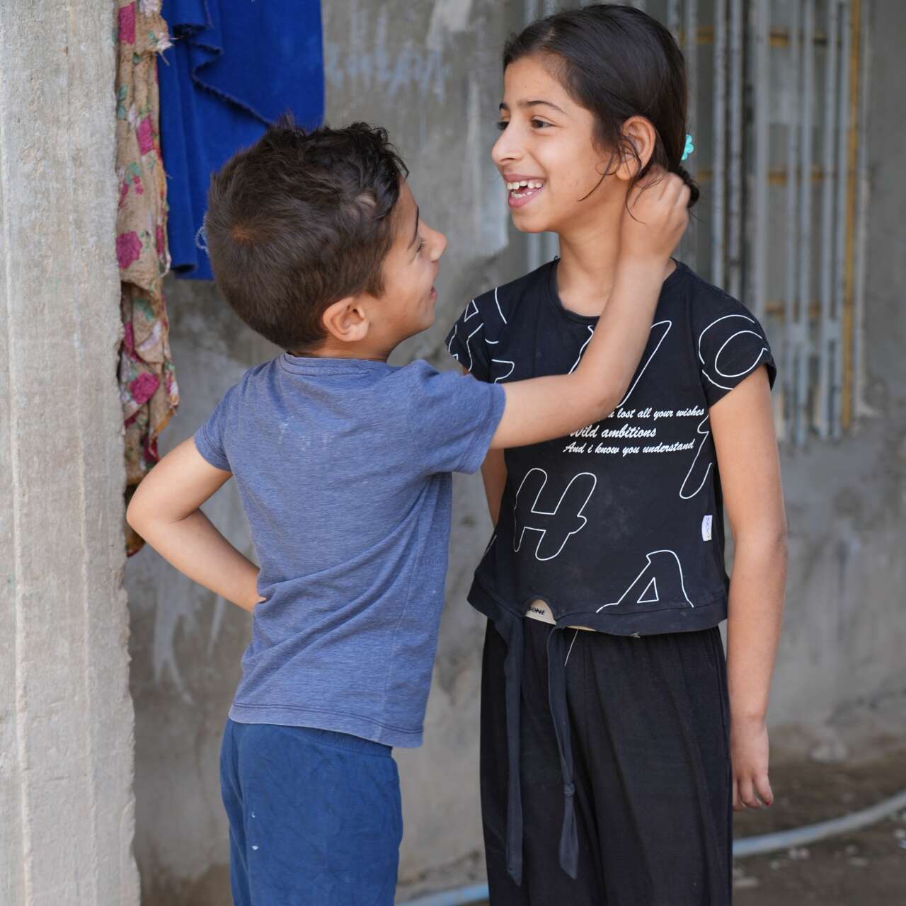 Two Iraqi children play together.