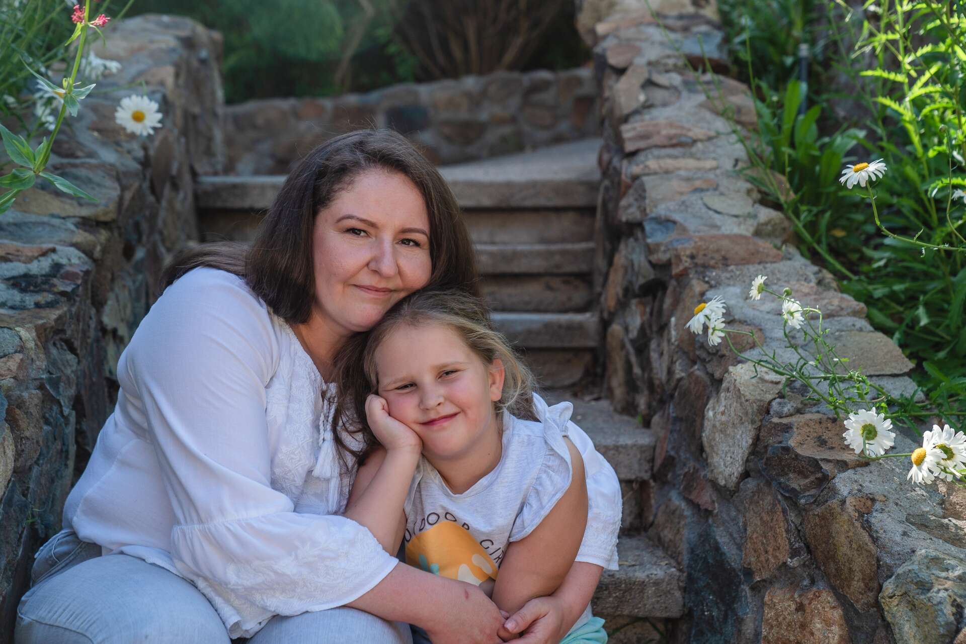 Yuliaa and her daughter pose for a portrait.