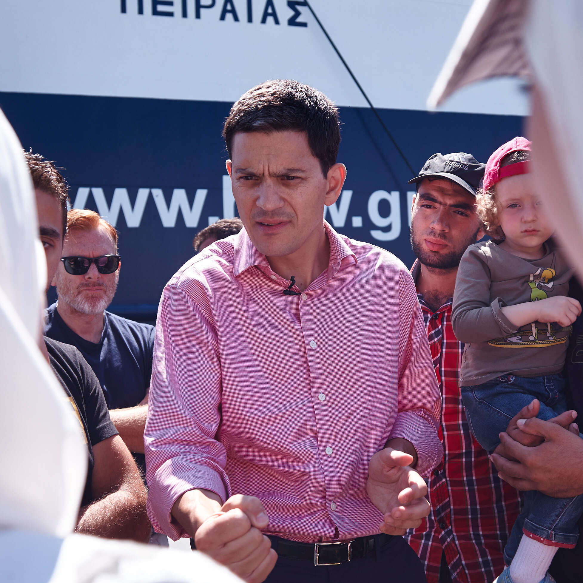 David Miliband in red shirt talking to a crowd