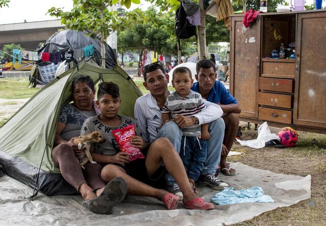 People sitting in fron of a small tent