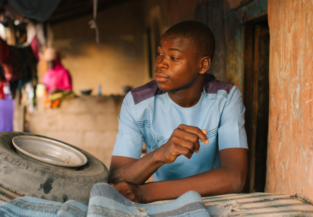 Musa poses for a picture at his shop.