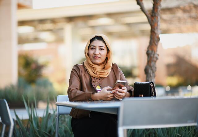 Mansora, ASU student from Afghanistan, sits outside.