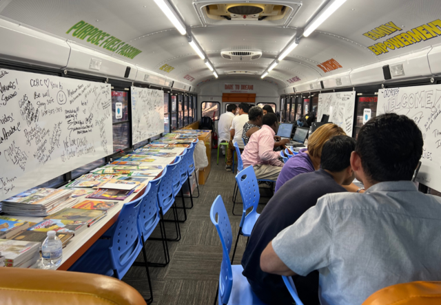 Parents and administrators in the mobile IMPACT hub registering for classes.